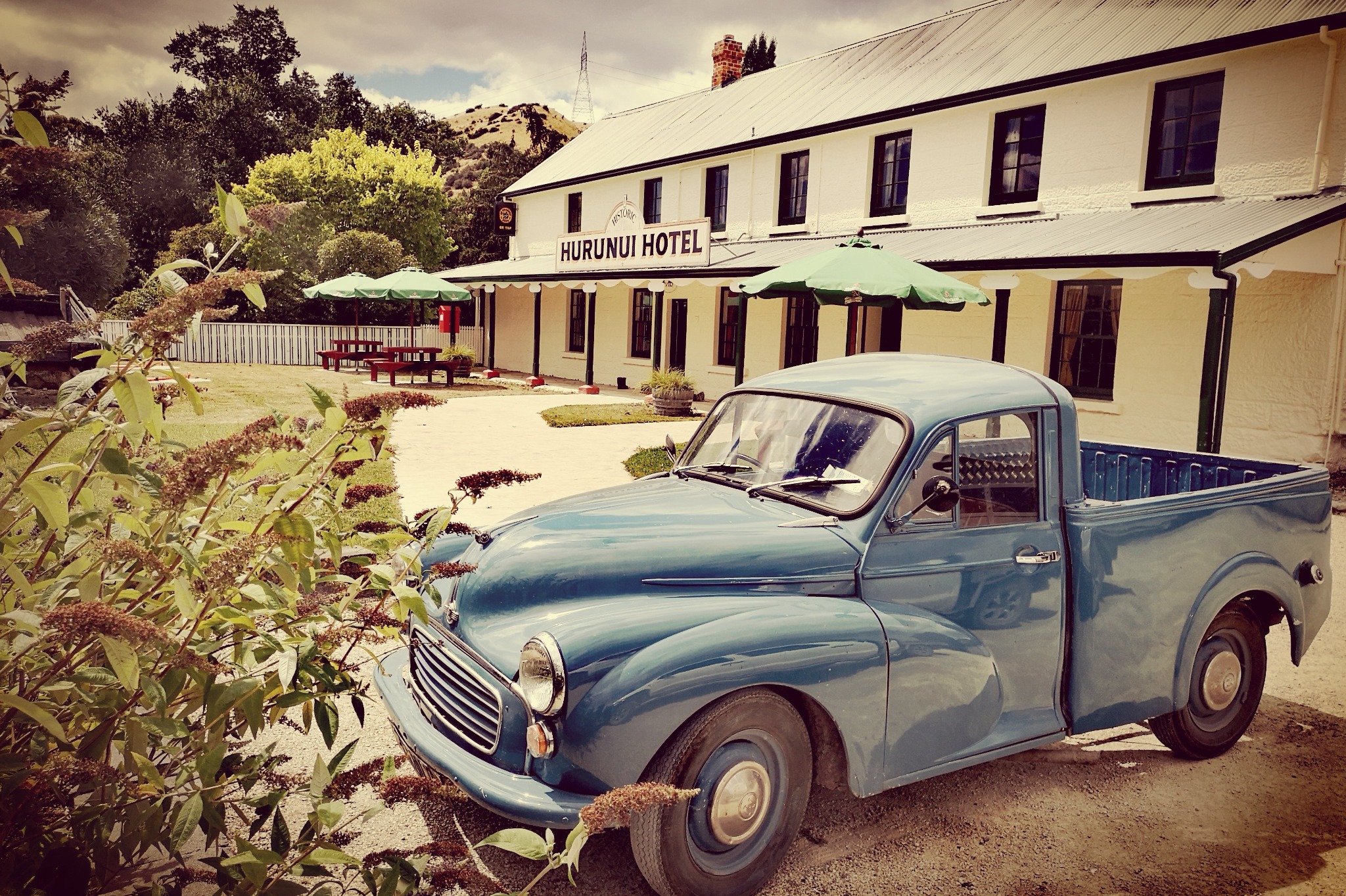 A vintage blue pickup truck outside the historic Hurunui Hotel